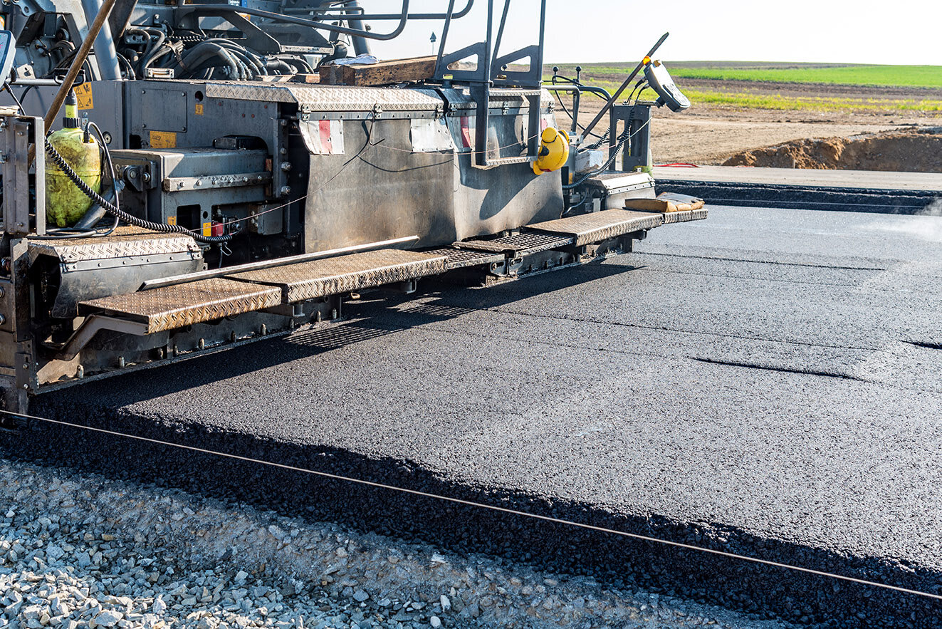 Asphalt paver machine laying a fresh mat of blacktop